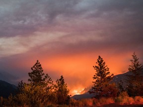 Wildfire burns above the Fraser River Valley near Lytton.