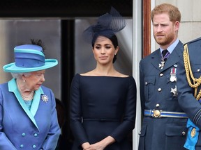 Queen Elizabeth II, Prince Harry, Duke of Sussex and Meghan, Duchess of Sussex on the balcony of Buckingham Palace as the Royal family attend events to mark the Centenary of the RAF on July 10, 2018 in London, England.