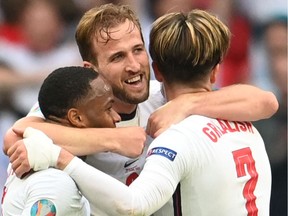 England forward Harry Kane, centre, celebrates with England forward Raheem Sterling, left, and England midfielder Jack Grealish after their win in the UEFA EURO 2020 Round of 16 game against Germany at Wembley Stadium in London on June 29.