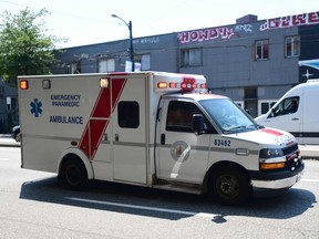 An ambulance is seen during the extreme hot weather in Vancouver on June 30, 2021. The B.C. Coroners Service is asking medical practitioners not to issue death certificates in cases where they believe the recent heat wave was a contributing factor.