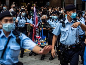 Activist Alexandra Wong (centre), also known as Grandma Wong, is taken away by police while protesting on the 24th anniversary of Hong Kong's handover from Britain, in Hong Kong on July 1, 2021.