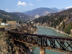 The charred remnants of the rail bridge, destroyed by a wildfire on June 30, is seen during a media tour by authorities in Lytton, British Columbia, Canada July 9, 2021.