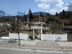 The charred remnants of a home, destroyed by a wildfire on June 30, are seen during a media tour by authorities in on British Columbia, Canada July 9, 2021.
