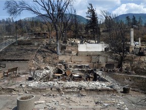 The charred remnants of buildings, destroyed by a wildfire on June 30, are seen during a media tour by authorities in on British Columbia, Canada July 9, 2021.