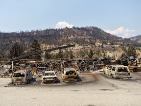The charred remnants of vehicles, destroyed by a wildfire on June 30, are seen during a media tour by authorities in Lytton, British Columbia, Canada July 9, 2021.