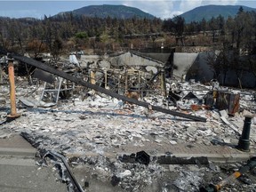 The charred remnants of homes and buildings, destroyed by a wildfire on June 30, are seen during a media tour by authorities in Lytton, British Columbia, Canada July 9, 2021.  REUTERS/Jennifer Gauthier