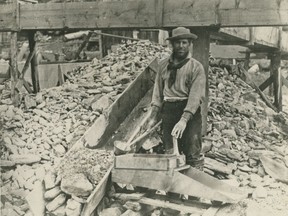 Miner Bill Phinney works a "hand rocker" on the Caledonia Claim at Williams Creek during the Cariboo Gold Rush in the British Columbia Interior in the 1860s.