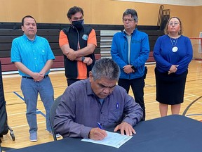 Chief Allan Tom of the Pauquachin First Nation signs a document calling for end to recent acts of violence and vandalism on southern Vancouver Island in Esquimalt on July 9, 2021.
