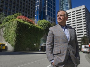 Jon Stovell of Reliance Properties stands near a parking garage at the corner of Melville and Thurlow Streets in downtown Vancouver, BC on Wednesday, April 14, 2021. Stovell would like to build a rental building on the site but his proposal does not comply with city policies.