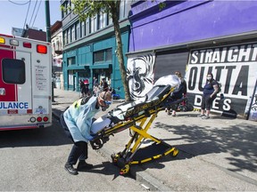 Paramedics respond to an emergency medical call in the 100-block East Hastings Street in Vancouver.