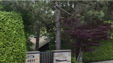 Behind this unassuming gate is a Vancouver mansion bought by a "student" for $31 million, in a common practice that has distorted Canadian real-estate prices.