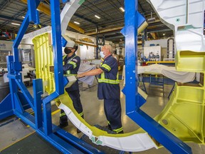 Technicians at ASCO work on the bulkhead for a F-35 jet.