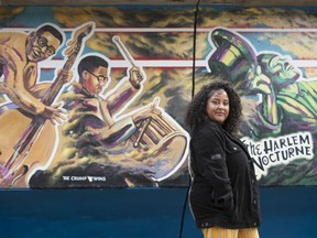 Krystal Paraboo is the project manager and curator of Black Strathcona Resurgence Project. She is standing next to a mural entitled Hope Through the Ashes: A Requiem for Hogan's Alley.