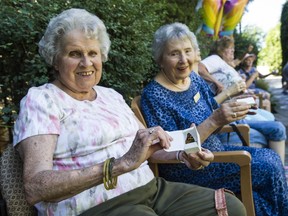 Butterlies are released by residents of the Gilmore Gardens seniors care home Patricia McKendrick (left) and Friedel Whiting in Richmond on Friday.