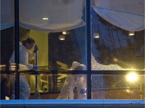 Workers clean around the scene of a shooting at Vancouver's Wall Centre in 2012.