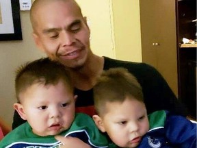 Robinson Russ, 37, seen here with his young sons in an undated family photo, was stabbed on April 4 in Vancouver's Downtown Eastside
