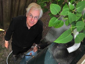 Hans Schreier with empty rain barrels at his home in Vancouver, BC., on July 27, 2021.