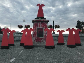 Most of the Captain Cook statue in downtown Victoria was pulled off its pedestal on Thursday night. Part of a leg was left behind, along with red markings on the base, and cutouts of red dresses.