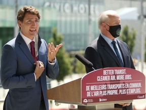 Prime Minister Justin Trudeau and Premier John Horgan take questions following a transit announcement during a press conference at Surrey City Hall in Surrey on Friday.