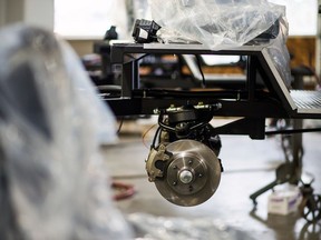 The wheel assembly and brake components of an electric truck are seen inside a manufacturing facility in British Columbia.