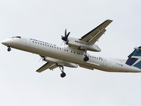 A Westjet Encore Bombardier DHC-8-402 aircraft lands at Edmonton International Airport in Nisku, Alberta on Monday, September 18, 2017.