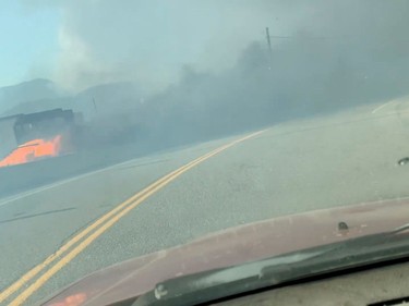 A car burns along a street during a wildfire in Lytton, British Columbia, Canada June 30, 2021 in this still image obtained from a social media video on July 1, 2021. 2 RIVERS REMIX SOCIETY/via REUTERS THIS IMAGE HAS BEEN SUPPLIED BY A THIRD PARTY. MANDATORY CREDIT. NO RESALES. NO ARCHIVES. MUST CREDIT "2 RIVERS REMIX SOCIETY / VIMEO.2RMX.CA".