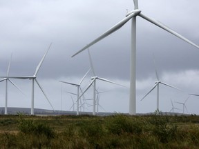 Wind turbines stand at Whitelee Windfarm, the U.K.'s largest onshore windfarm. The latest IPCC report released Monday says the world must switch to clean energy now to avoid crossing the 1.5 C warming threshold.