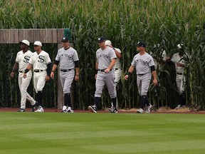 Members of the Chicago White Sox and the New York Yankees, in early 20th-century versions of the uniforms those teams once wore, take to the field in Dyersville, Iowa, for the Field of Dreams game on Thursday.