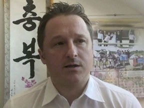 In this image made from video taken on March 2, 2017, Michael Spavor, director of Paektu Cultural Exchange, talks during a Skype interview in Yangi, China. Global Affairs Canada says detained Canadian businessman Michael Spavor received a visit from consular officials in China today.