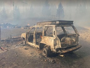 A burnt-out vehicle in front of a home that has been reduced to ashes on Paxton Valley Road, about 1 km east of Monte Lake and Highway 97. Photo: Courtesy of Scottie Duncan [PNG Merlin Archive]