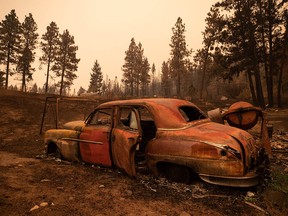 The remains of a classic car are seen on a property destroyed by the White Rock Lake wildfire in Monte Lake east of Kamloops on Saturday, Aug. 14, 2021.