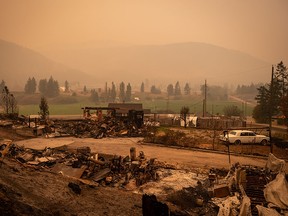 Thick smoke fills the air and nearly blocks out the sun on a property destroyed by the White Rock Lake wildfire in Monte Lake, B.C.