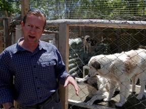 Pen Farthing, founder of British charity Nowzad, an animal shelter, stands in front of a cage on the outskirts of Kabul May 1, 2012.