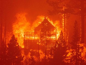 Flames consume multiple homes as the Caldor fire pushes into South Lake Tahoe, Calif., on Aug. 30, 2021.