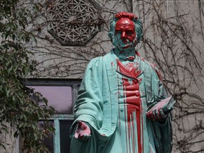 Red paint covers the defaced Ryerson University statue of Egerton Ryerson on June 2, 2021, following the discovery of the remains of 215 children on the site of British Columbia's former Kamloops Indian Residential School.
