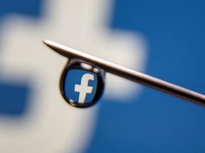 Facebook logo is reflected in a drop on a syringe needle in this illustration photo taken on March 16, 2021.