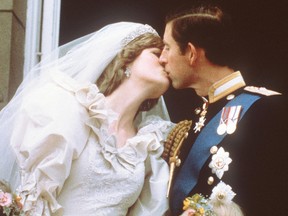 In this file photo taken on July 29, 1981, Charles, Prince of Wales, kisses his bride, Lady Diana, on the balcony of Buckingham Palace when they appeared before a huge crowd, after their wedding in St Paul's Cathedral.