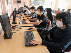 Students wearing face masks attend computer lessons in a classroom at Atatürk Vocational and Technical Anatolian High School in Ankara on October 8, 2020. (Photo by Adem ALTAN / AFP) (Photo by ADEM ALTAN/AFP via Getty Images) ORG XMIT: 0