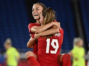 Vancouver penalty-kick hero Julia Grosso is all smiles, jumping into the arms of Chilliwack’s Jordyn Huitema after scoring the golden goal in the Olympic women’s soccer final against Sweden on Aug. 6, 2021 in Yokohama, Japan. Canada’s women’s soccer team took the gold medal.