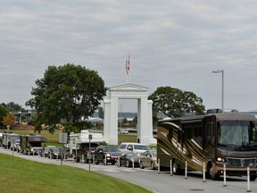 Travellers line up to enter Canada at the Peace Arch border crossing in Surrey, British Columbia, Canada Aug. 9, 2021.