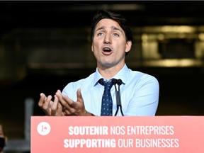 Prime Minister Justin Trudeau gives a news conference after visiting ETI Converting Equipment during his election campaign tour in Longueuil, Quebec, Canada Aug. 16, 2021.