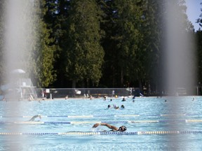 People swim at Second Beach outdoor pool during a period of warm weather in Vancouver.