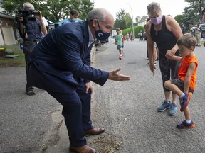 Conservative Leader Erin O’Toole greets some neighbourhood children after making an announcement on affordable housing Thursday, August 19, 2021 in Ottawa.