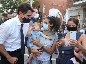 Justin Trudeau greets supporters during a campaign stop in his Papineau riding in Montreal on Aug. 15, 2021.