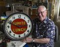 Horologist Ray Saunders with the historic White Lunch antique clock at his Richmond shop in 2021.