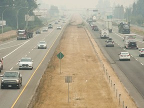 Traffic moves along the Trans-Canada Highway in Chilliwack on a stifling hot day, as drivers deal with the smoke coming from Interior forest fires on Friday.