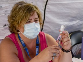 A nurse prepares a vial of the COVID-19 vaccine at a mobile immunization clinic. Creston has one of the lowest vaccination rates in B.C.