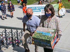 Green MLAs Adam Olsen and Sonia Furstenau after receiving a 150,000-name petition to stop old-growth logging.