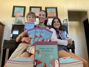 Jean Paetkau and her children, Jacob and Haley, with copies of their book, Rumpa and the Snufflewort.