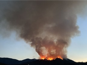 Skaha Creek fire crested over ridge near Penticton early Monday morning.